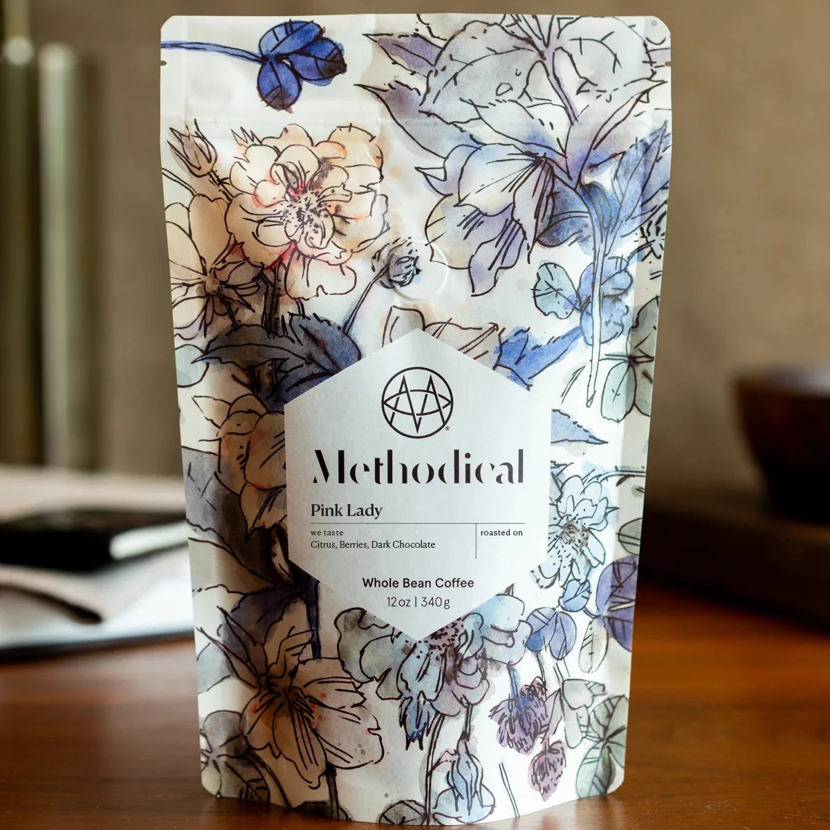 Methodical coffee package with floral design on a wooden surface